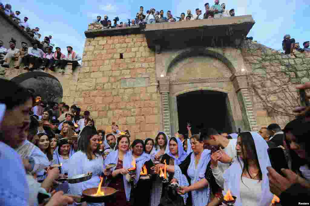 Iraqi Yazidis visit the Lalish Temple, on the day of a ceremony for the occasion of Red Wednesday, the celebration of the Yazidi New Year, in Shekhan district, in Duhok province, Iraq, April 18, 2023.