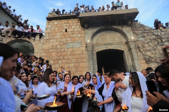 FILE - Iraqi Yazidis visit the Lalish Temple, on the day of a ceremony for the occasion of Red Wednesday, the celebration of the Yazidi New Year, in Shekhan district, in Duhok province, Iraq, April 18, 2023. (REUTERS/Ari Jalal)