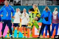 Sweden's Elin Rubensson jumps in the arms of goalkeeper Zecira Musovic celebrating at the end of the Women's World Cup quarterfinal soccer match between Japan and Sweden at Eden Park in Auckland, New Zealand, Friday, Aug. 11, 2023.