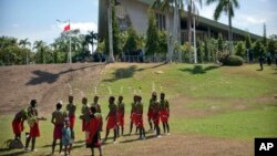 FILE - Performers in traditional clothing stand outside of Parliament Haus in Port Moresby, Papua New Guinea, on Nov. 16, 2018.