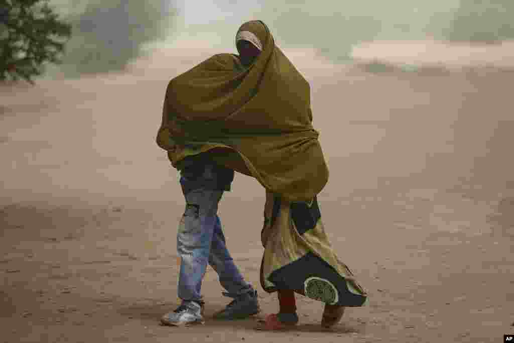 Somali refugee children cover as a dust storm moves across the Dadaab refugee camp in northern Kenya, Thursday, July 13, 2023. One of the world&#39;s largest refugee camps offers a stark example of the global food security crisis with thousands of people fleeing Somalia in recent months to escape drought and extremism but finding little to eat when they arrive at the Dadaab camp in neighboring Kenya.&nbsp;