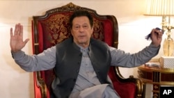 Pakistan's former prime minister Imran Khan talks with reporters regarding the current political situation and the ongoing cases against him at his residence, in Lahore, Aug. 3, 2023. 