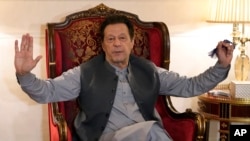 FILE - Pakistan's former prime minister Imran Khan talks with reporters regarding the current political situation and the ongoing cases against him at his residence, in Lahore, Pakistan, Aug. 3, 2023. 