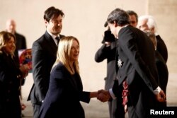 FILE - Italian Prime Minister Giorgia Meloni and her partner Andrea Giambruno wait to meet Pope Francis at the Vatican, Jan. 10, 2023.