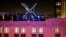 FILE - Workers install lighting on an "X" sign atop the company headquarters, formerly known as Twitter, in downtown San Francisco, July 28, 2023.