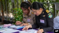 Thai officer check document from potential candidates to become members of Thailand's next Senate arrive at the Phaya Thai district office in Bangkok, May 20, 2024.