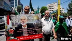 Palestinians attend a protest after the assassination of Hamas leader Ismail Haniyeh in Iran, in Hebron in the Israeli-occupied West Bank, July 31, 2024. 