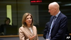 FILE - The Netherland's Minister of Health Ernst Kuipers, right, speaks with European Commissioner for Health and Food Safety Stella Kyriakides during a meeting of EU health ministers at the European Council building in Brussels on March 14, 2023.