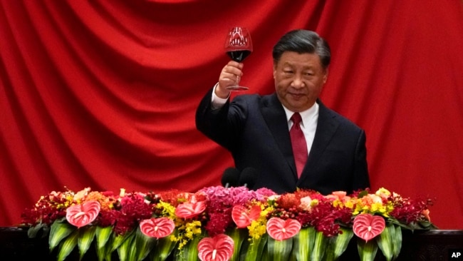 FILE - Chinese President Xi Jinping makes a toast after delivering a speech at the Great Hall of the People in Beijing on Sept. 28, 2023.