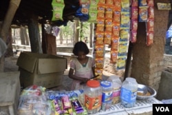 This girl selling goods is like many tribal children in Jharkhand, India, who are forced to take up adult responsibilities in the wake of domestic violence and poverty. (Arti Munda/VOA)