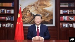 In this photo released on Dec. 31, 2023 by Xinhua News Agency, Chinese President Xi Jinping delivers a New Year message in Beijing to ring in 2024.