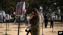 An Israeli soldier weeps at the marker for a loved one kidnapped on Oct. 7 in a cross-border attack by Hamas at the Nova music festival, after a press conference at the site in Re'im, southern Israel, Jan. 5, 2024.