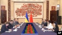 In this photo released by Xinhua News Agency, Ukraine's Foreign Ministry Dmytro Kuleba, third from left, holds talks with China's Foreign Minister Wang Yi at a meeting in the southern Chinese city of Guangzhou on July 24, 2024.