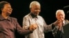 FILE - Former president of South Africa, Nelson Mandela (C) is escorted by his wife Graca Machel (L) and former U.S. President Jimmy Carter (R) during a ceremony marking his 89th birthday in Johannesburg, July 18, 2007. 