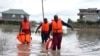 FILE—Kenyan Red Cross personnel and volunteers conduct search and rescue missions, around houses submerged by flood water in Machakos county, Kenya, April 22, 2024. 