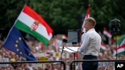 Peter Magyar, a rising challenger to Hungarian Prime Minister Viktor Orban, addresses people at a campaign rally in the rural city of Debrecen, Hungary, May 5, 2024. 