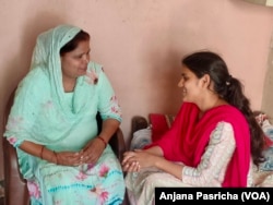 Sangeeta Malik, head of the Khanpur Kalan village, talking to her daughter.