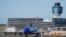 FILE - LaGuardia Airport's air traffic control tower, right, is shown as planes line up for take-off, May 25, 2023, in New York.