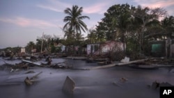 Debris from collapsed home and felled trees litter the shore line of the coastal community of El Bosque, in Tabasco, Mexico, Nov. 30, 2023. Flooding driven by a sea-level rise and increasingly brutal winter storms destroyed the Mexican community. 