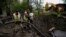 Municipal workers pump water from a crater after a Russian attack on mental hospital №3 in Kharkiv, Ukraine, April 27, 2024. Russian drones early Sunday also struck the Black Sea city of Mykolaiv. 