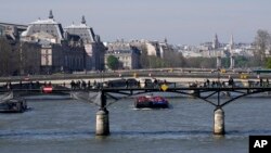 Barges travel along the River Seine in Paris, April 5, 2023. A costly and complex clean-up is resuscitating the River Seine just in time for it to play a starring role in the 2024 Paris Olympics. 