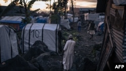 The imam of the mosque of the informal camp for displaced Muslims who fled attacks by the M23 rebels waits for nightfall to break the Ramadan fast in Goma, eastern Democratic Republic of Congo, March 27, 2023.