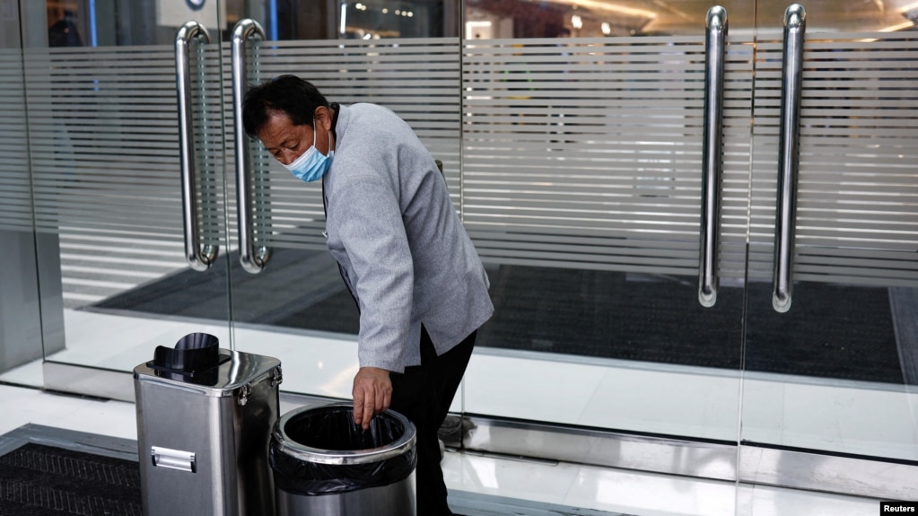 Cleaning worker Hu Dexi, 67, works at a shopping mall in Beijing, China April 10, 2024. (REUTERS/Tingshu Wang)