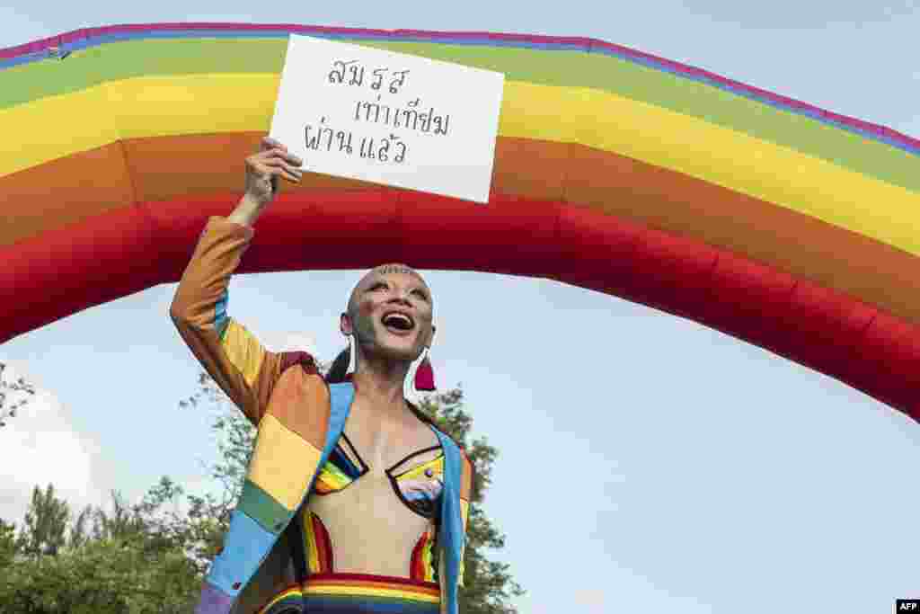 A member of the LGBTQ community celebrates after the Thai parliament passed the final senatorial vote on the same sex marriage bill, at Government House in Bangkok.