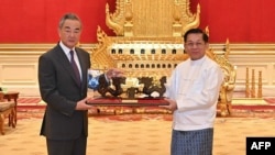 This photograph taken and released on Aug. 14, 2024, by the Myanmar Military Information Team shows Myanmar's military chief Min Aung Hlaing, right, meeting with China's Foreign Minister Wang Yi in Naypyidaw. 