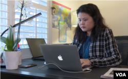 Publisher Soben Ung works on a recent edition of the Khmer Post USA in her home office. (Sisovann Pin/VOA)