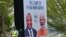 A security worker stands next to a banner featuring Papua New Guinea's Prime Minister (L) and India's Prime Minister Narendra Modi in Port Moresby, May 18, 2023. 