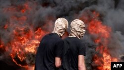 Palestinians burn tires amid clashes with Israeli security forces during the funeral of 19-year-old Labib Damidi in the occupied West Bank town of Huwara.(Photo by Jaafar ASHTIYEH / AFP)