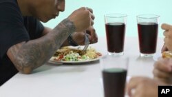 A young man who was imprisoned for belonging to a gang eats his lunch at the Vida Libre” or “free life,” rehabilitation center, in Santa Ana, El Salvador, April 29, 2023.