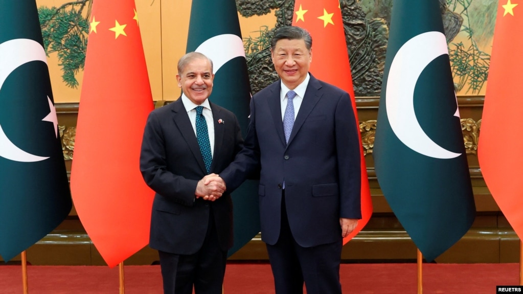 Chinese President Xi Jinping, right, and Pakistani Prime Minister Shehbaz Sharif shake hands at the Great Hall of the People in Beijing, China, June 7, 2024.