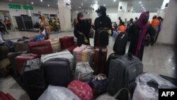 Fleeing Nigerian students in Sudan prepare to get their luggage after being evacuated from Sudan to Nigeria at the Nnamdi Azikwe International Airport in Abuja, Nigeria, May 4, 2023.