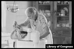 FILE - In this undated photo, Carrie Severt washing clothes in Alleghany County, North Carolina. Photo by Lyntha Scott. Courtesy of The Library of Congress)