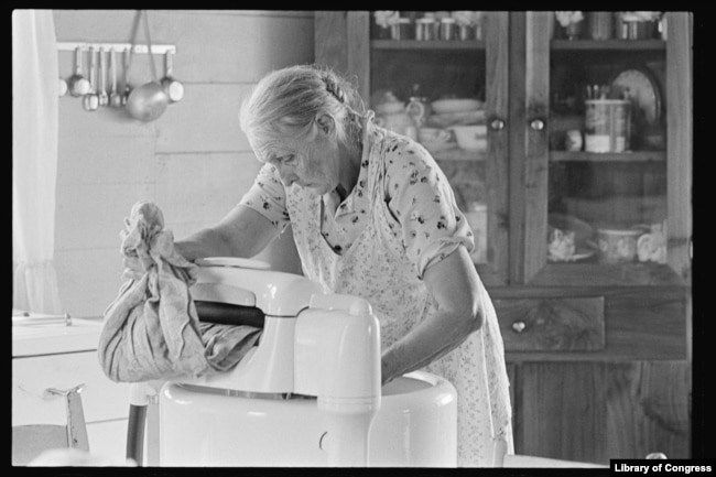 FILE - In this undated photo, Carrie Severt washing clothes in Alleghany County, North Carolina. Photo by Lyntha Scott. Courtesy of The Library of Congress)