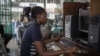 INTERNET cafe in Kinshasa / cybercafe / girl on computer / digital literacy Africa