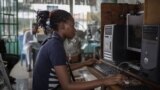 INTERNET cafe in Kinshasa / cybercafe / girl on computer / digital literacy Africa