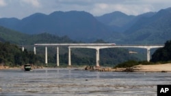 FILE - A Chinese high-speed train moves across a bridge over the Mekong River, north of the Laotian city of Luang Prabang on Dec. 12, 2023.