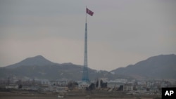 FILE - A North Korean flag flutters in North Korea's village Gijungdong as seen from an South Korea's observation post inside the demilitarized zone in Paju, South Korea, during a media tour, March 3, 2023.