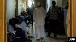 Patients wait outside the clinics at the Medani Heart Centre hospital in Wad Madani, the capital of the Al-Jazirah state in east-central Sudan, on May 25, 2023.