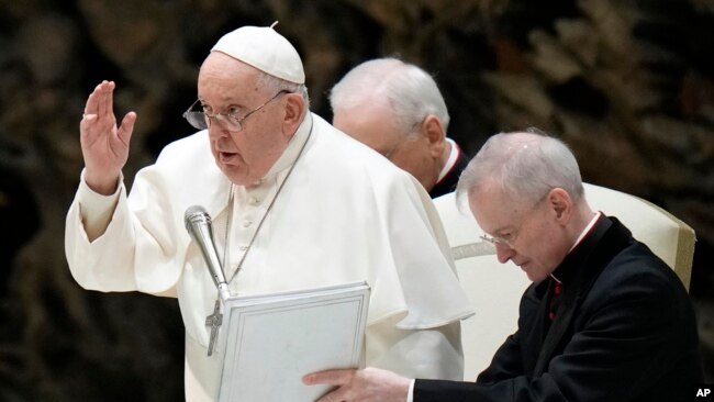 Pope Francis delivers his blessing at the end of his weekly general audience in the Paul VI Hall at the Vatican, Dec. 27, 2023.