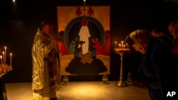Christian Orthodox priest Hennadii Kharkivskyi leads a service at the chapel basement of the Church of the Intercession of the Blessed Virgin Mary in Lypivka near Kyiv, Ukraine, April 28, 2024. 