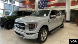 A Ford F-150 truck on display in the showroom at Suburban Ford of Sterling Heights in Michigan, February 28, 2024.