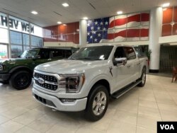 A Ford F-150 truck on display in the showroom at Suburban Ford of Sterling Heights in Michigan, February 28, 2024.