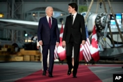 U.S. President Joe Biden and Canadian Prime Minister Justin Trudeau arrive for a gala dinner at the Canadian Aviation and Space Museum, March 24, 2023, in Ottawa, Ontario.