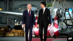 FILE- President Joe Biden and Canadian Prime Minister Justin Trudeau arrive for a gala at the Canadian Aviation and Space Museum, March 24, 2023, in Ottawa, Ontario.