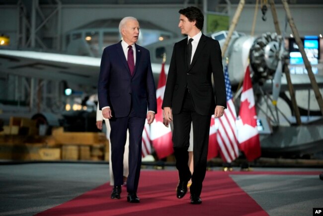 U.S. President Joe Biden and Canadian Prime Minister Justin Trudeau arrive for a gala dinner at the Canadian Aviation and Space Museum, March 24, 2023, in Ottawa, Ontario.