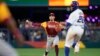 Los jugadores de Venezuela reciben a Anthony Santander (25) tras conectar un jonrón en el primer inning ante Puerto Rico en el Clásico Mundial de béisbol, el domingo 12 de marzo de 2023 en Miami. (AP Foto/Wilfredo Lee)